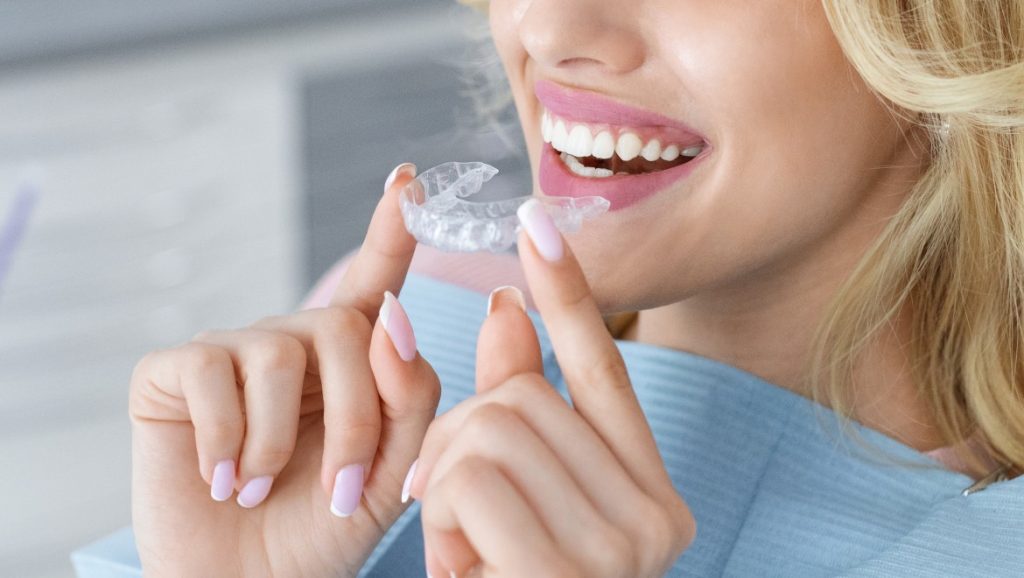 Woman holding dental implant